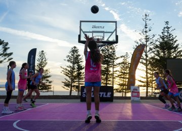 Image of children playing basketball at an outdoor 3x3 basketball court